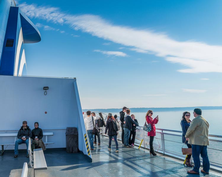 Passengers on the sunny deck of the ferry